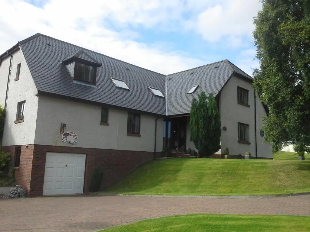 a large white house with a garage at Kimcraigan B&B in Brackla