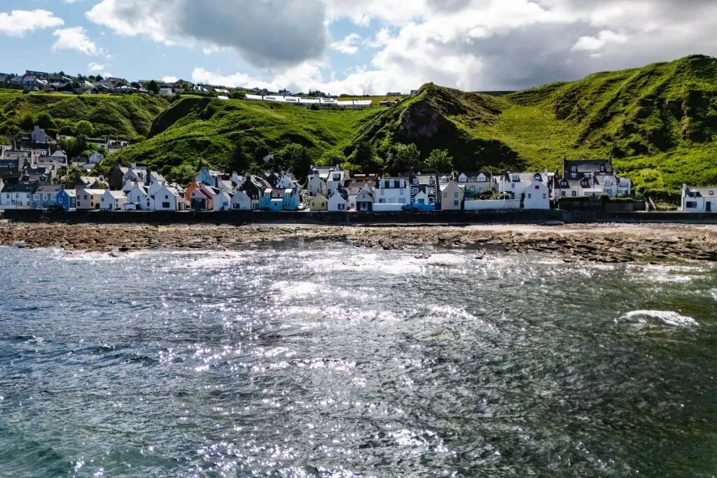 a group of houses on the shore of a beach at Soundwaves, Seatown, Gardenstown in Gardenstown