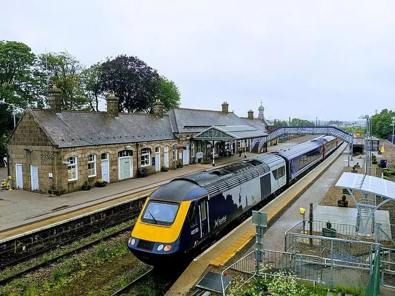 a train is pulling into a train station at Bright and cosy central flat in Inverurie in Inverurie