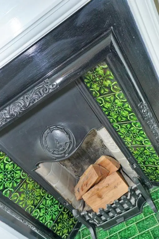 a fireplace with some wood on top of it at Bright and cosy central flat in Inverurie in Inverurie