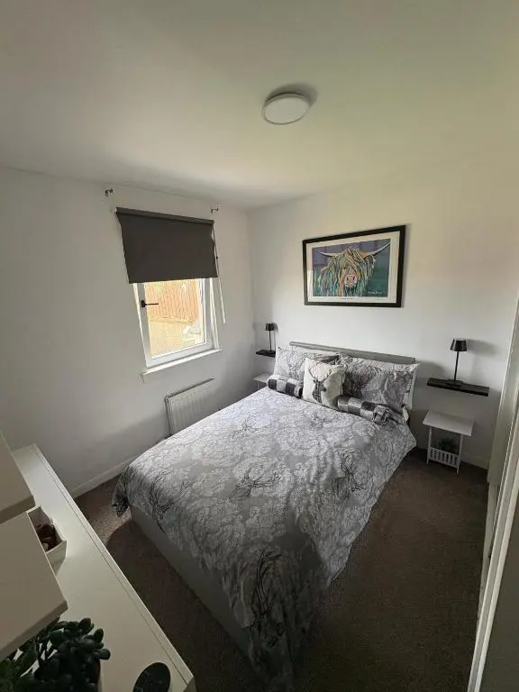 a bedroom with a bed and a window at Cloverdale Aparthotel in Aberdeen