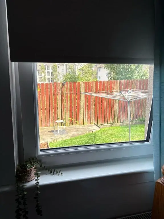 a window with a view of a fence at Cloverdale Aparthotel in Aberdeen