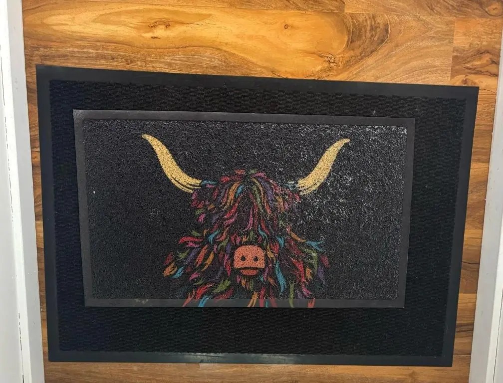 a framed picture of a bull with horns at Cloverdale Aparthotel in Aberdeen
