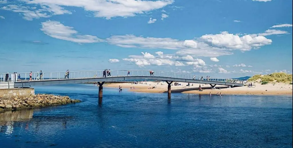 a bridge over a body of water with people walking on it at Parkview holiday lodge in Lossiemouth