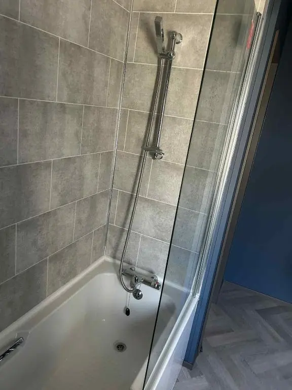 a shower in a bathroom with a bath tub at Parkview holiday lodge in Lossiemouth