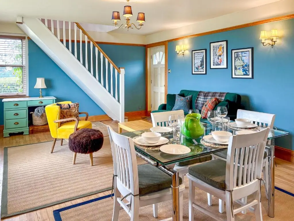 a dining room with a table and chairs at The Cottage At Mains House in Tain