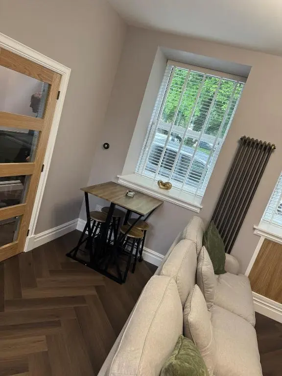 a living room with a couch and a table at Luxury central townhouse in Wick
