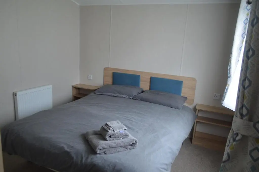 a bedroom with a bed with towels on it at B9 at The Old Mill Holiday Park in Dyke