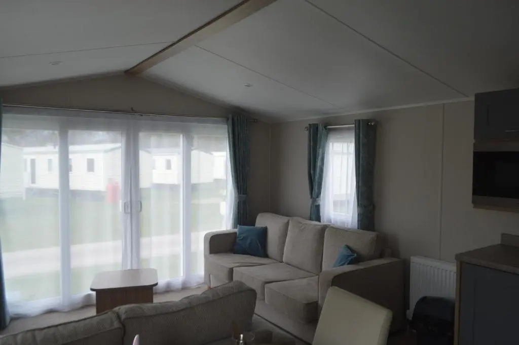 a living room with a couch and a window at B9 at The Old Mill Holiday Park in Dyke