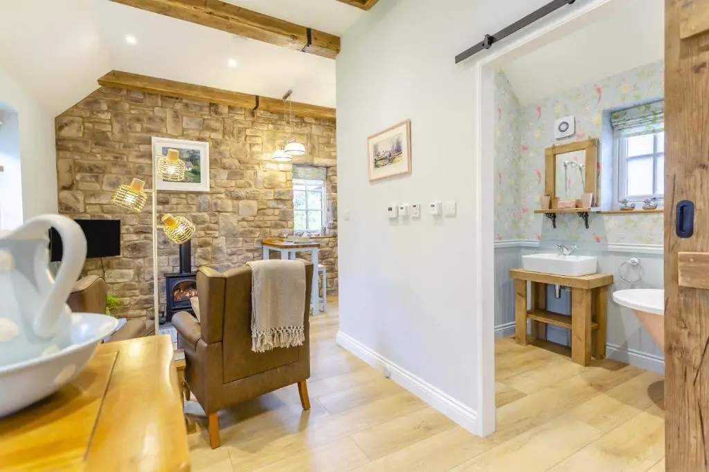 a large bathroom with a stone wall at 1 Bed in Drumnadrochit oc-t32404 in Drumnadrochit