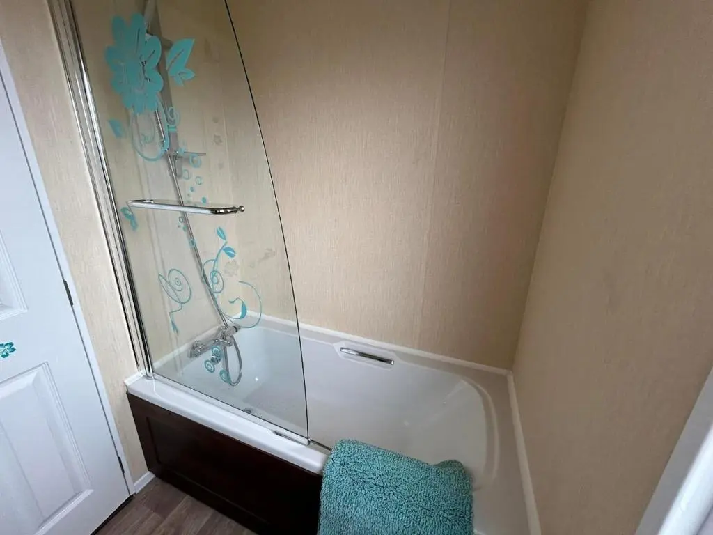 a shower with a glass door in a bathroom at Rivendale Lodge in Burghead