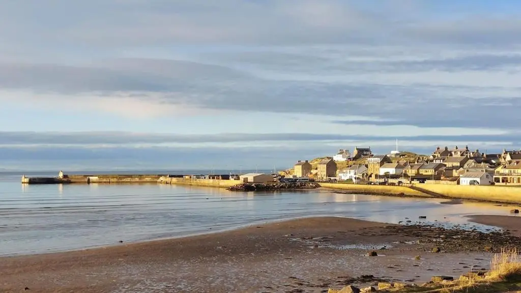 a group of houses on the shore of a body of water at Rivendale Lodge in Burghead