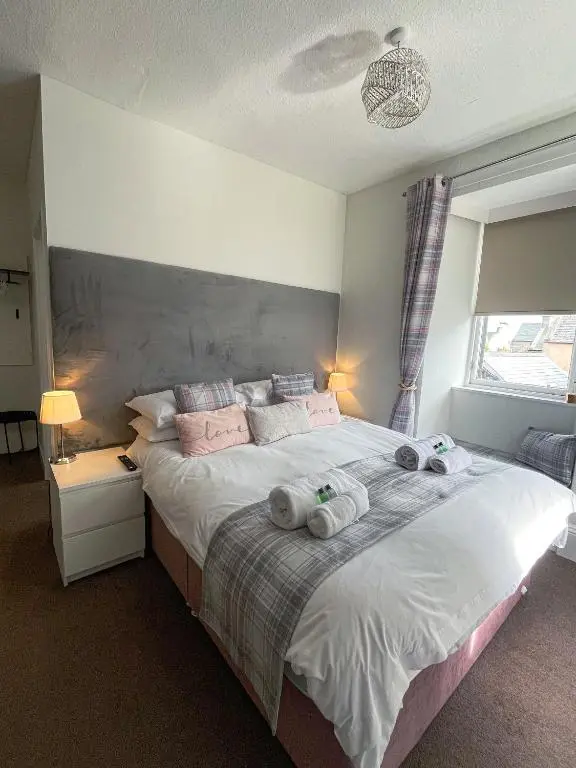a bedroom with a large bed with towels on it at Crown and Anchor Inn in Findhorn