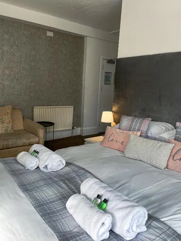a hotel room with two beds with towels at Crown and Anchor Inn in Findhorn