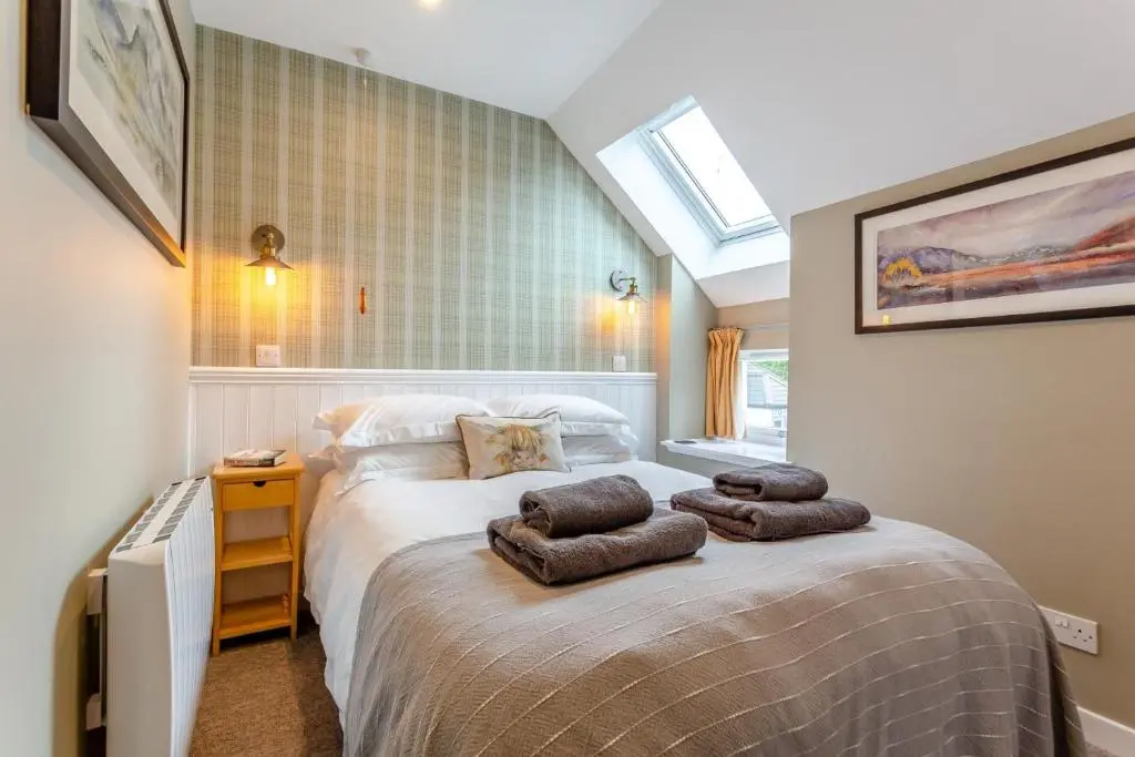 a bedroom with a bed with two pillows on it at 2 Bed in Newtonmore oc-d32413 in Newtonmore