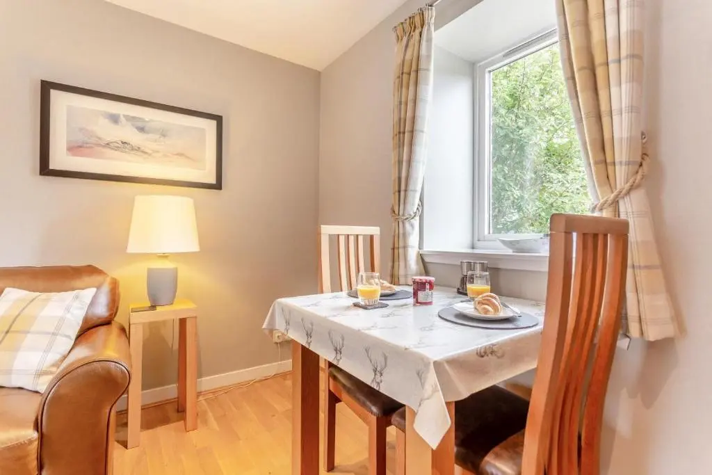 a dining room with a table and a window at 1 Bed in Newtonmore oc-l32415 in Newtonmore