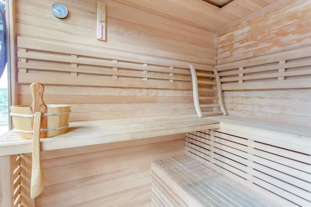 a wooden sauna with a wooden chair in it at 1 Bed in Newtonmore oc-l32415 in Newtonmore