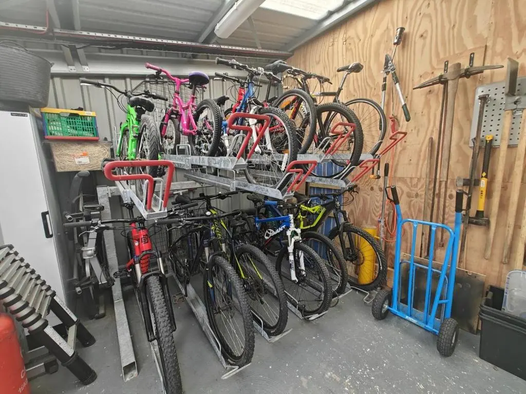 a bunch of bikes are hanging on a wall at 1 Bed in Newtonmore oc-b32417 in Newtonmore