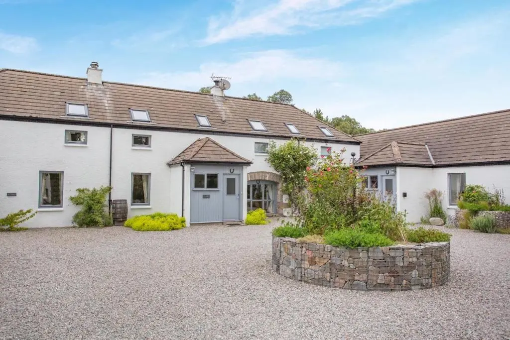 an exterior view of a house with a courtyard at 2 Bed in Newtonmore oc-e32418 in Newtonmore