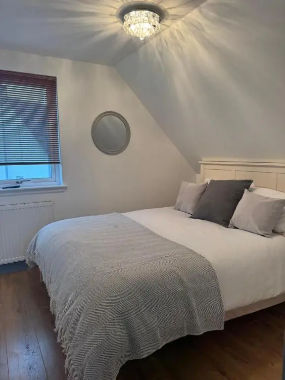 a bedroom with a bed with a ceiling at Daviot Lodge apartment in Daviot