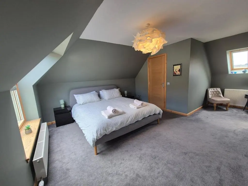 a bedroom with a bed with two stuffed animals on it at 2 Bed House - free parking, short walk to City centre in Inverness