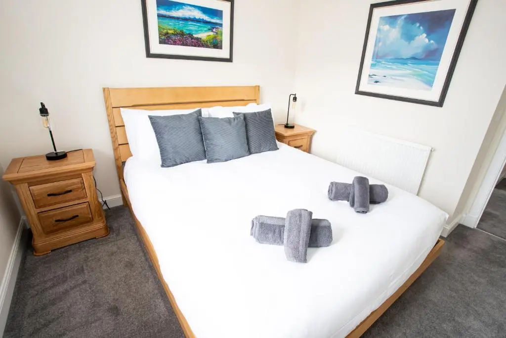 two beds in a bedroom with two teddy bears on them at City and Loch Ness Blend in Inverness