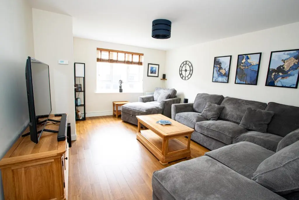a living room with a couch and a tv at City and Loch Ness Blend in Inverness