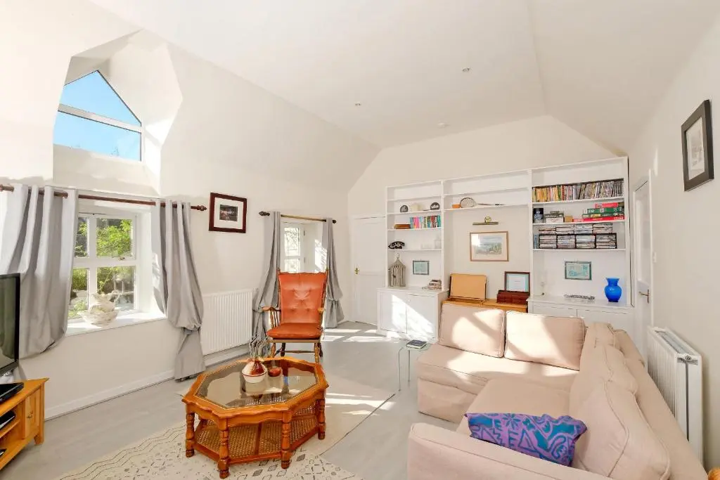 a living room with a couch and a table at Finest Retreats - Corrennie School Cottage in Inverurie