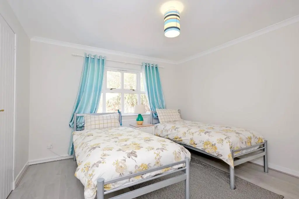 a bedroom with two beds and a window at Finest Retreats - Corrennie School Cottage in Inverurie