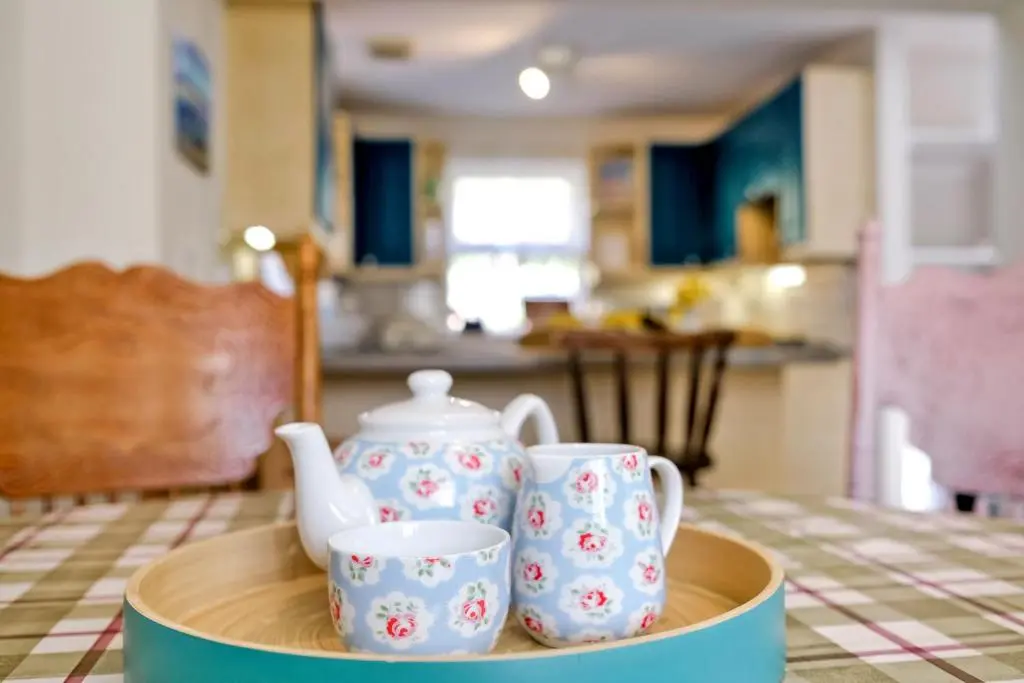 a tray with two tea pots and cups on a table at Finest Retreats - Corrennie School Cottage in Inverurie