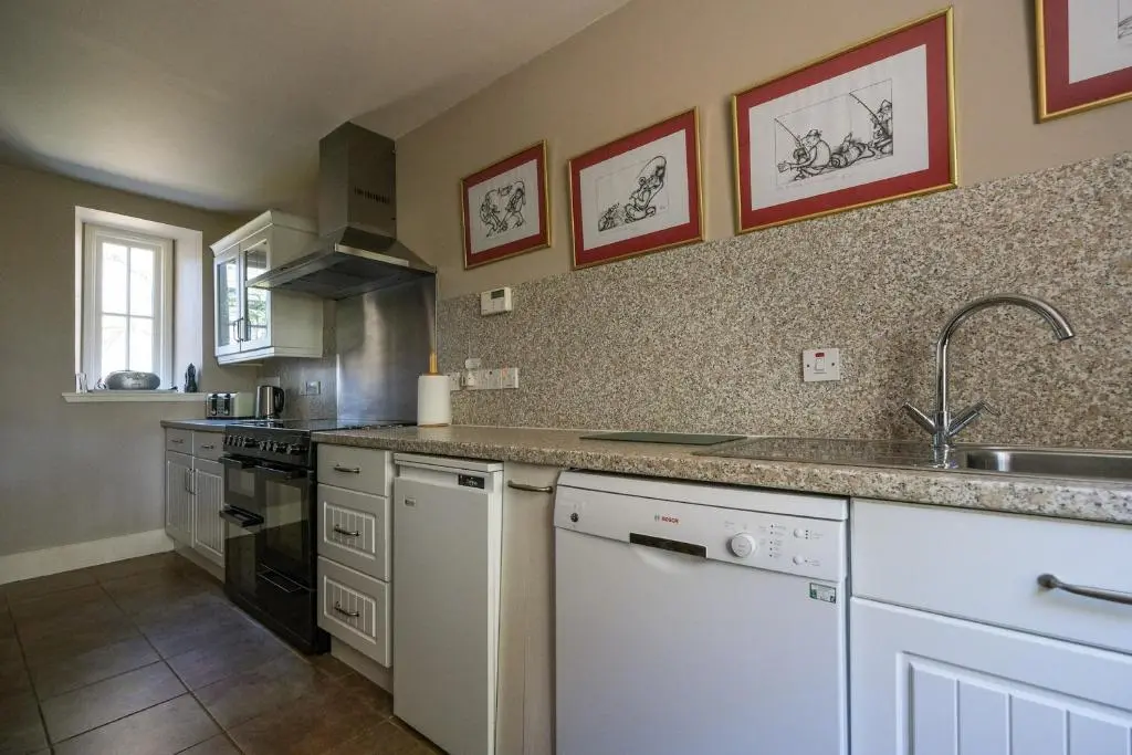 a kitchen with a sink and a counter top at Gledfield Estate Holiday Cottages in Lower Gledfield