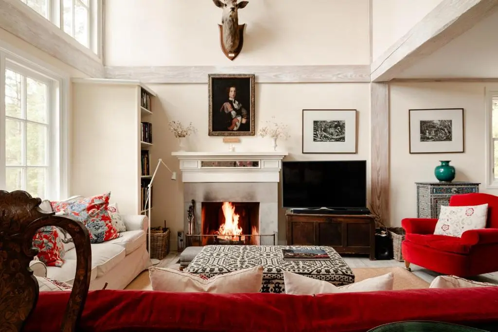 a living room with a fireplace and a couch at Glencarnie - Seasgair Lodges in Boat of Garten