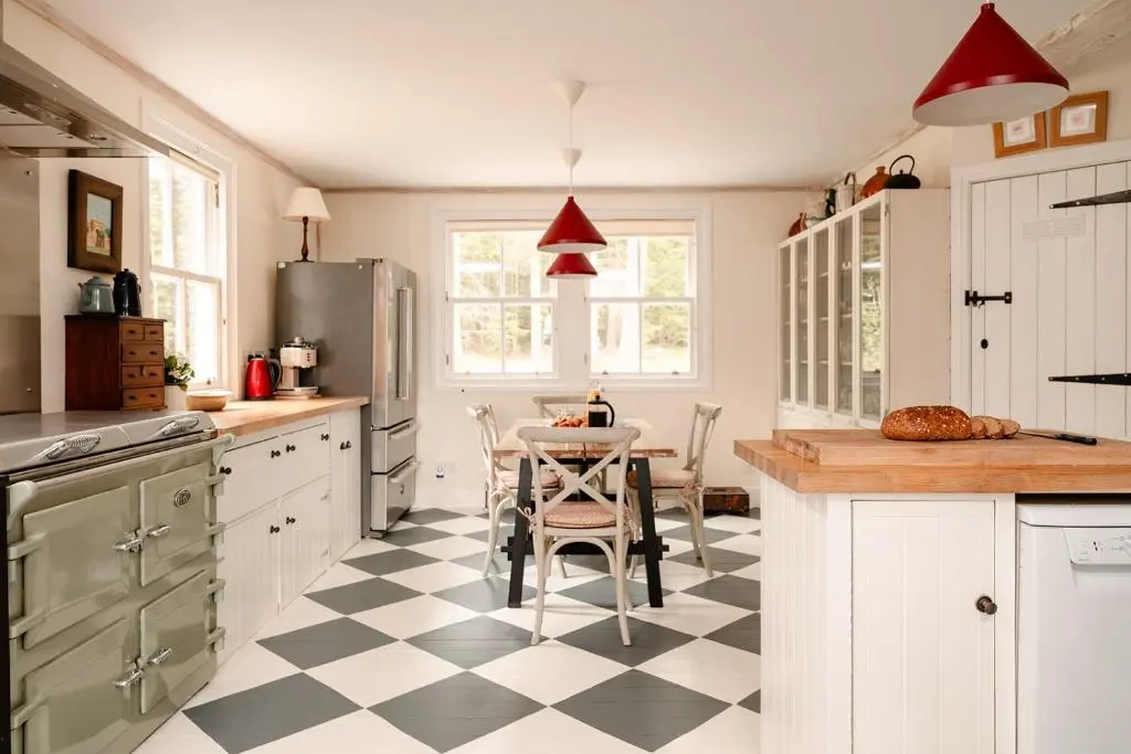 a kitchen with a black and white checkered floor at Glencarnie - Seasgair Lodges in Boat of Garten