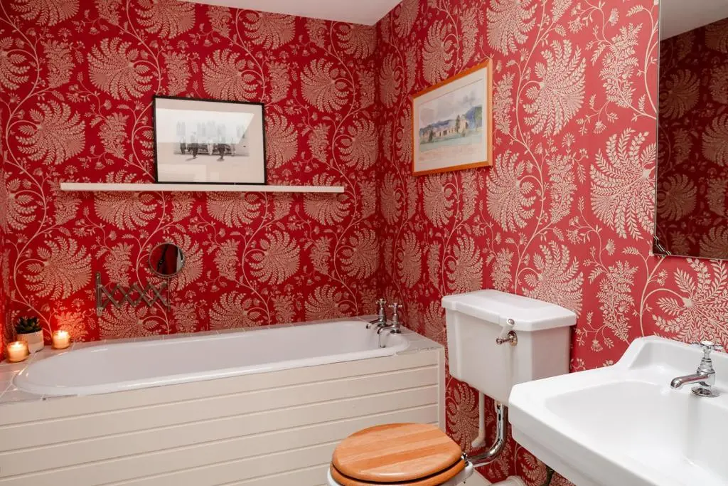 a bathroom with a tub and a toilet and a sink at Glencarnie - Seasgair Lodges in Boat of Garten