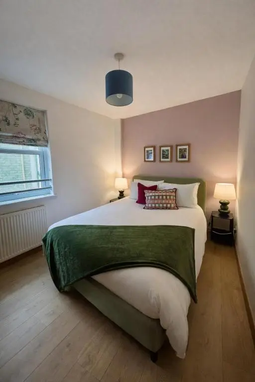 a bedroom with a large bed and two lamps at The Inver Nest in Inverness