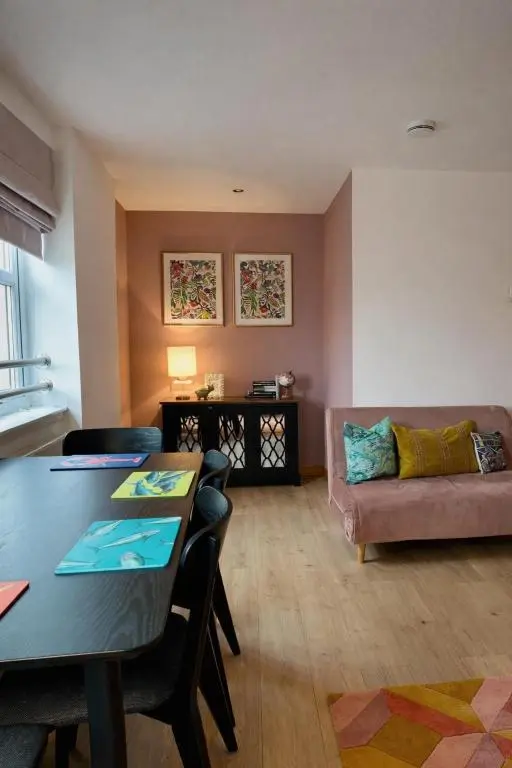a living room with a table and a couch at The Inver Nest in Inverness