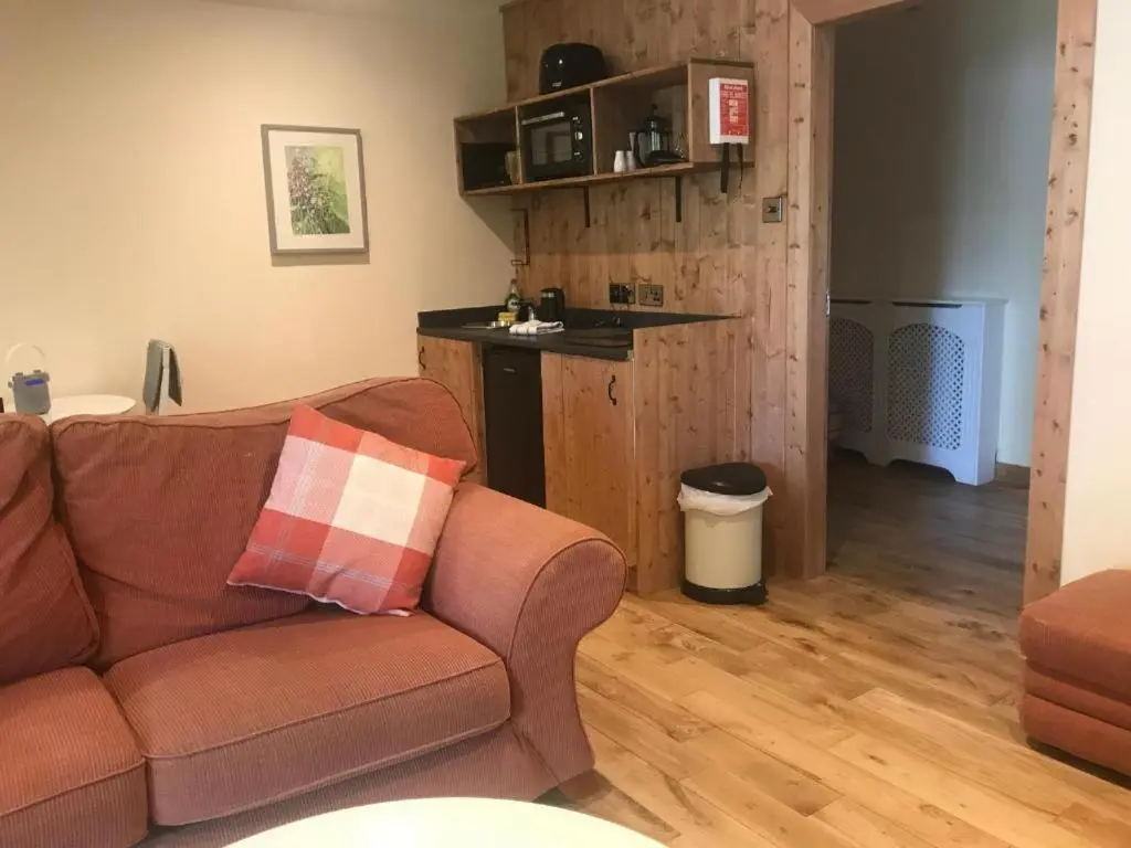 a living room with a couch and a table at Cosy Apartment in the Highlands in Muir of Ord