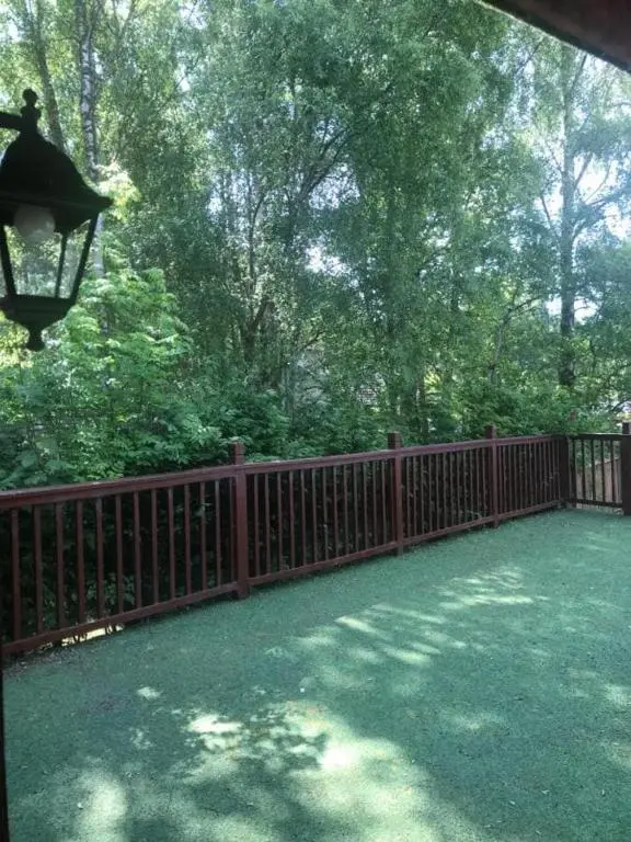 a fence with a light on top of a yard at Cosy Apartment in the Highlands in Muir of Ord