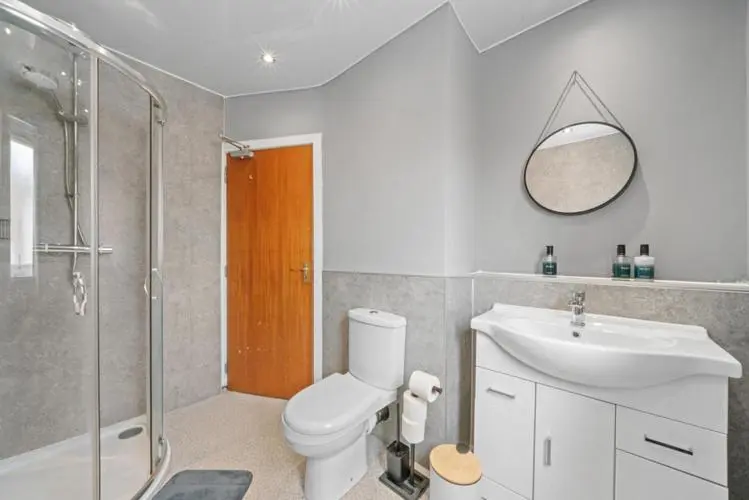 a bathroom with a toilet and a sink and a shower at Cloudhowe Cottage Ensuite Rooms & Studio Inverness in Inverness