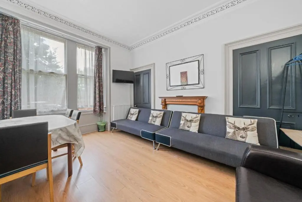 a living room with a couch and a table at Central Inverness Hideaway - 2 Bedroom Flat in Inverness