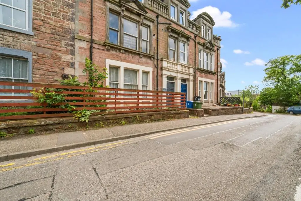 an empty street in front of a brick building at Central Inverness Hideaway - 2 Bedroom Flat in Inverness