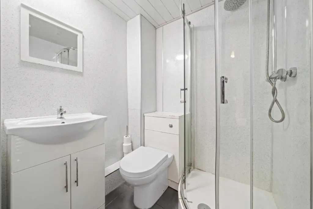 a bathroom with a toilet and a shower and a sink at 2 Bedroom Inverness Apartment - Perfect Location in Inverness