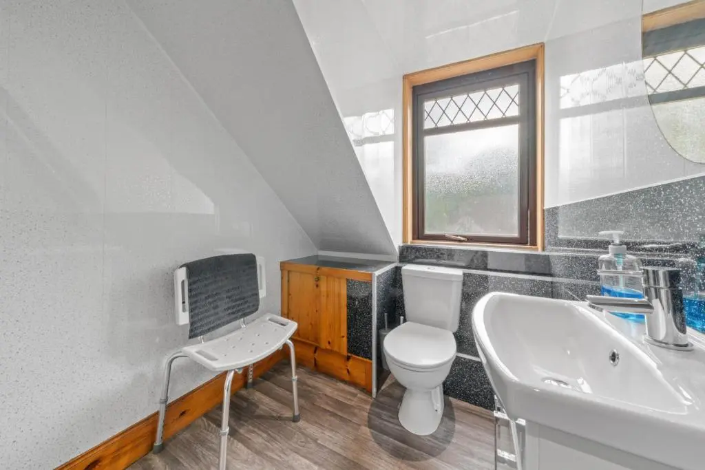 a bathroom with a toilet and a sink at Struy Guest House - Inverness in Inverness