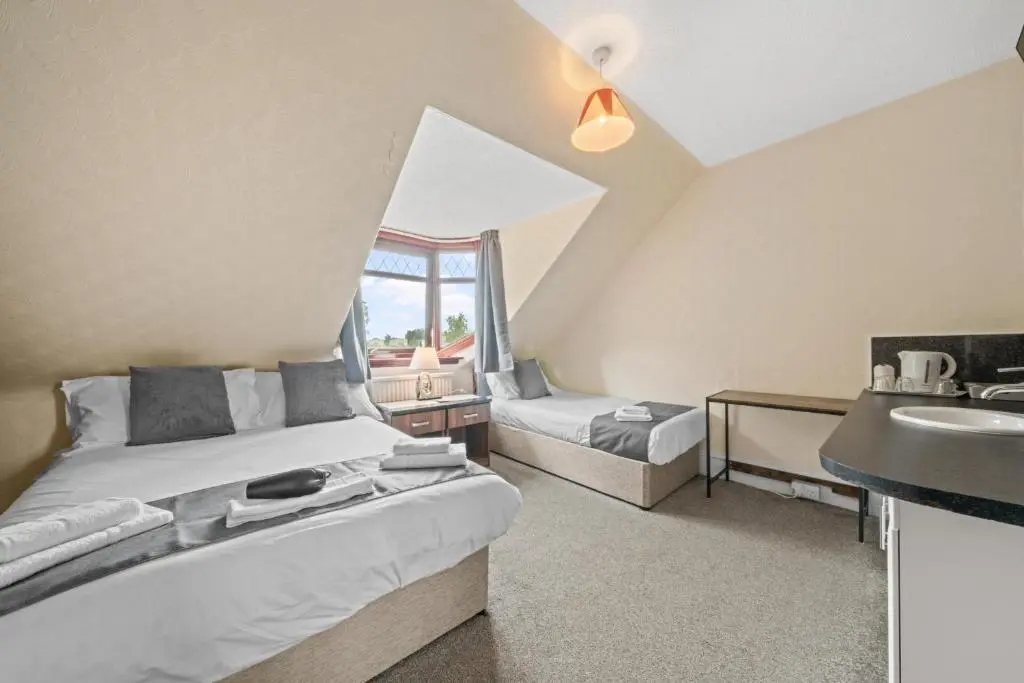 a bedroom with a bed and a sink in a room at Struy Guest House - Inverness in Inverness