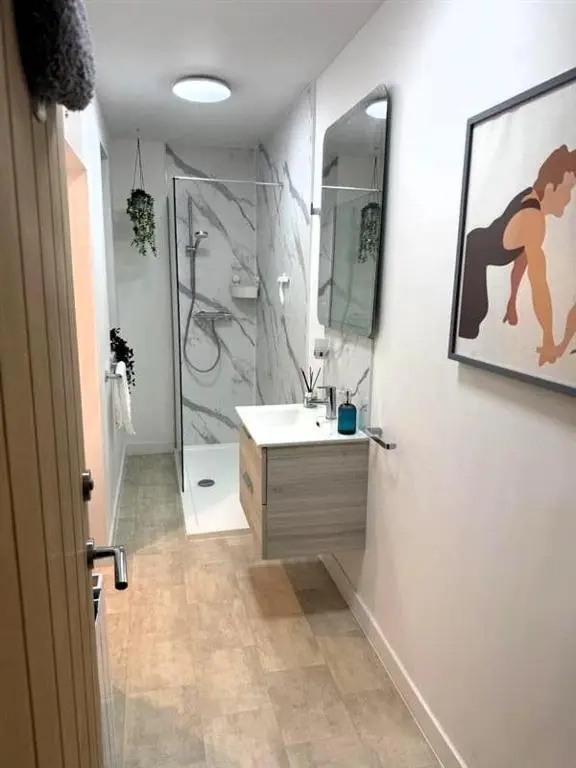 a bathroom with a shower and a sink and a mirror at Meadowside-Stylish Newly Renovated 2 bed property in Insch