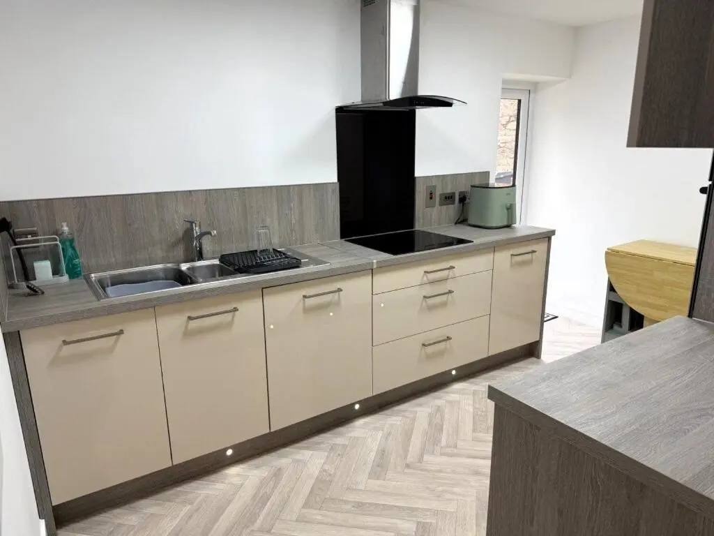 a kitchen with a sink and a counter top at Meadowside-Stylish Newly Renovated 2 bed property in Insch
