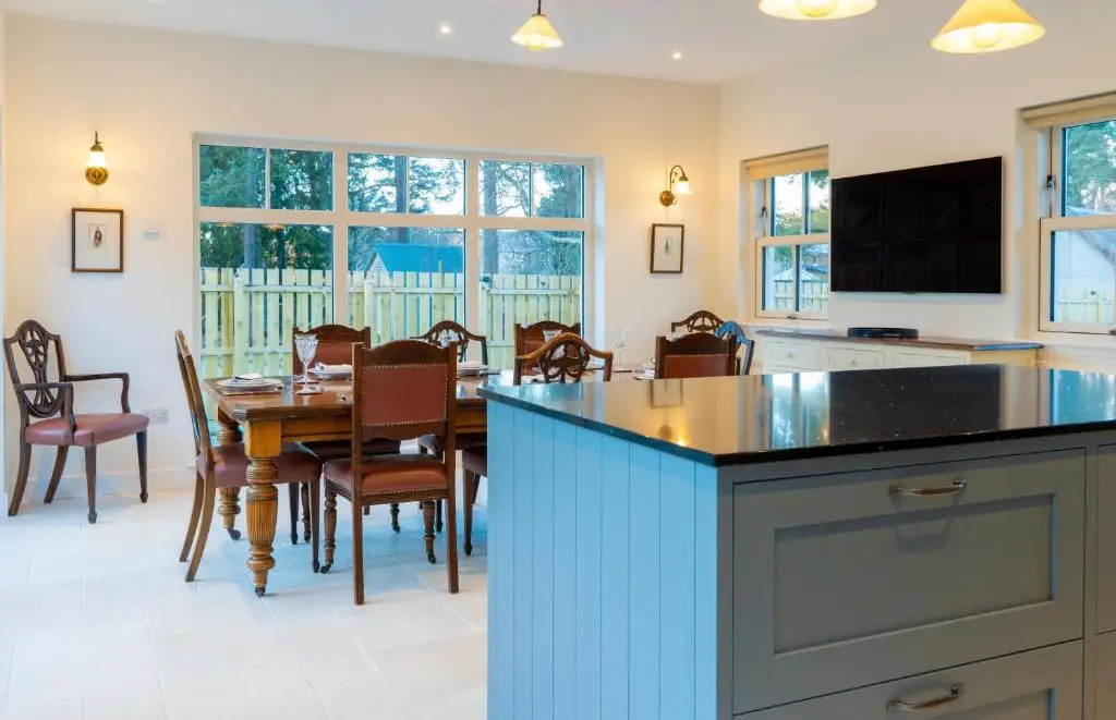 a kitchen and dining room with a table and chairs at Old Coach House in Braemar