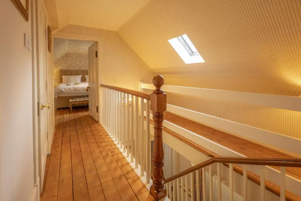 a hallway with a stairway leading to a bedroom at Laggandhu in Nethy Bridge
