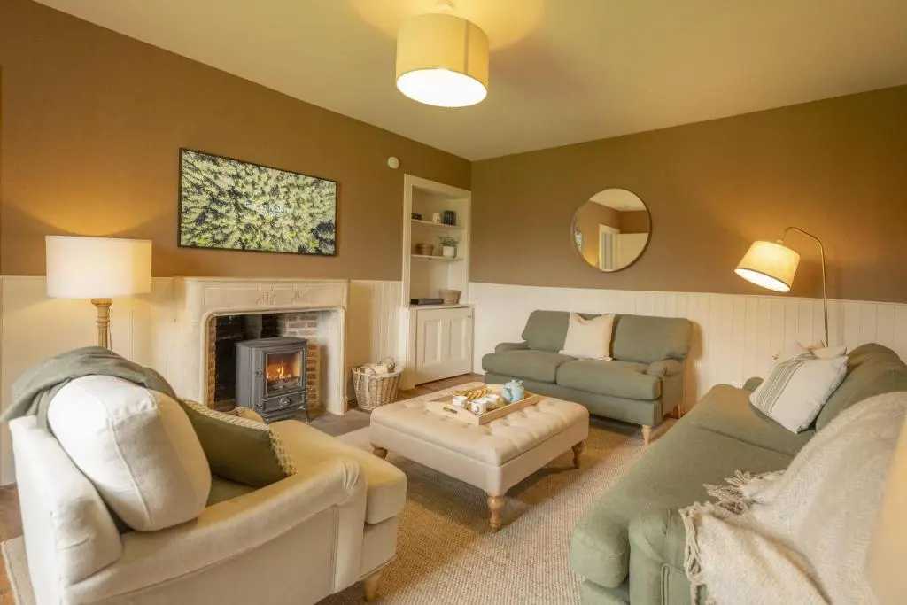 a living room with two couches and a fireplace at Laggandhu in Nethy Bridge