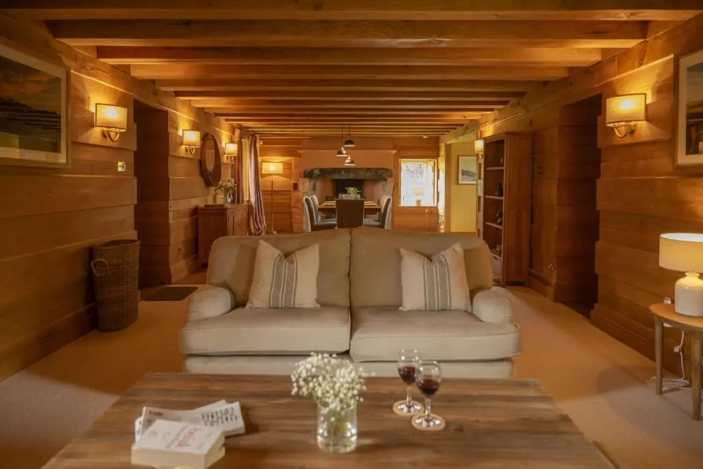 a living room with a couch and a table at Drum Cottage in Nethy Bridge